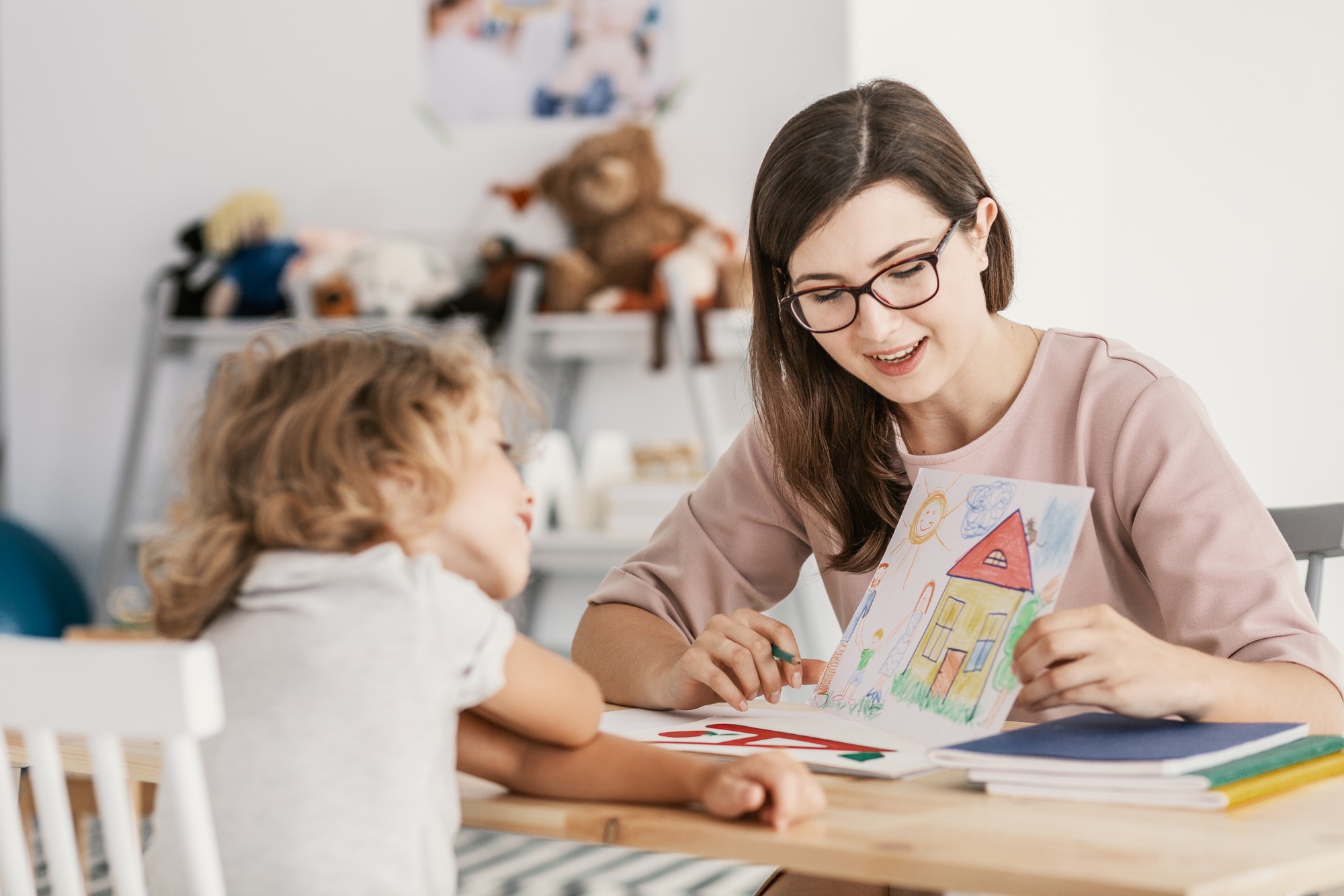 A professional child education therapist having a meeting with a kid in a family support center.; Shutterstock ID 1147615607; purchase_order: Limited 7/26/21